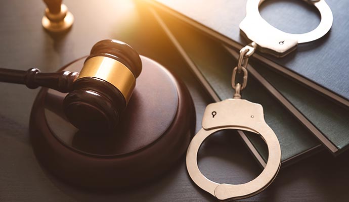 A gavel and a pair of handcuffs