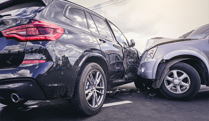 Collision between a black SUV and a silver vehicle