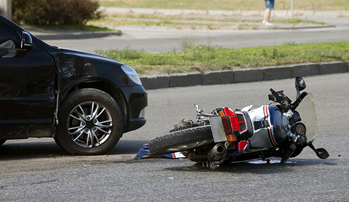 Black car and motorcycle collision damage