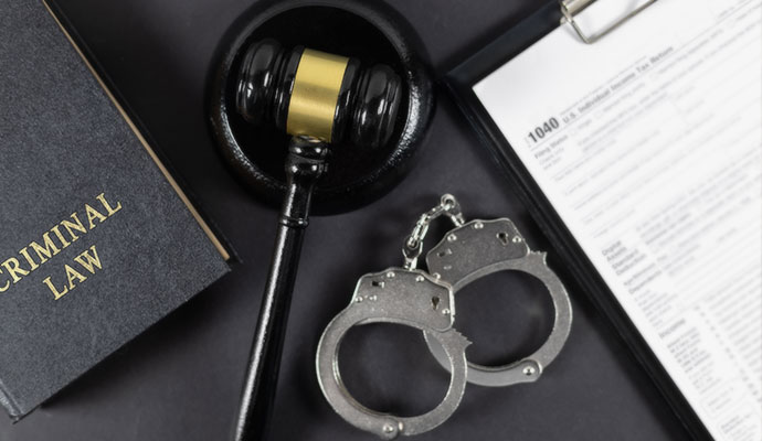 Criminal law book and handcuffs