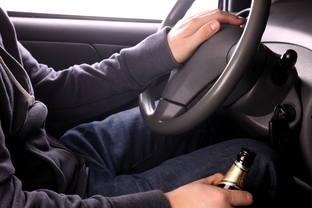 Man drinking while driving a vehicle