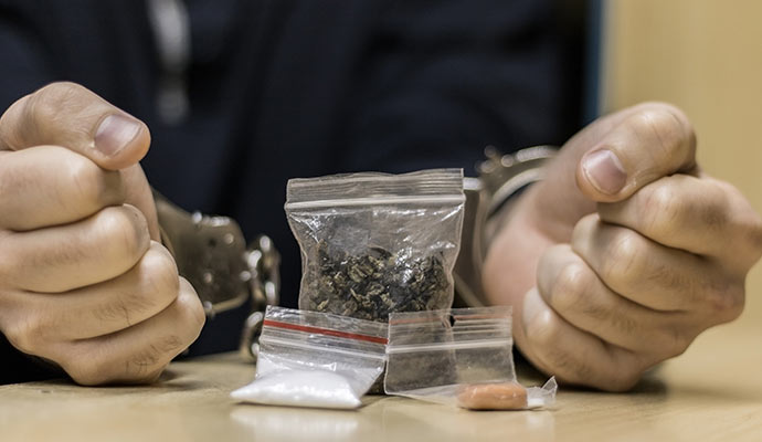 Handcuffed suspect with illegal substances