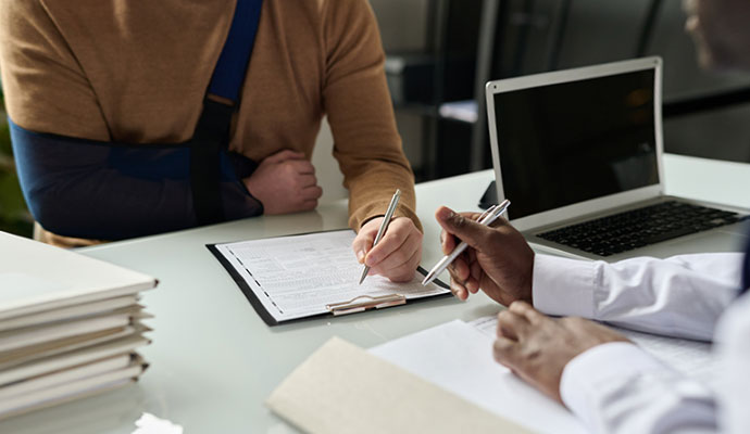 Injured client signing legal documents
