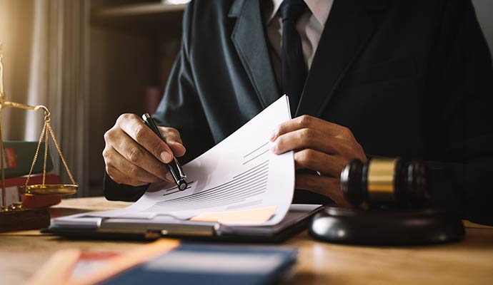Legal professional reviewing documents in an office