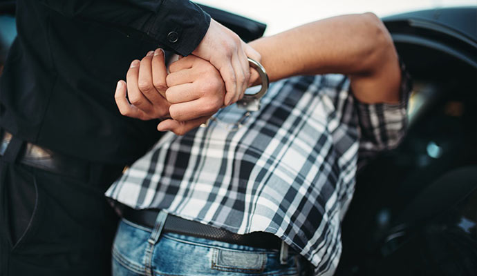 Police arresting suspect with handcuffs