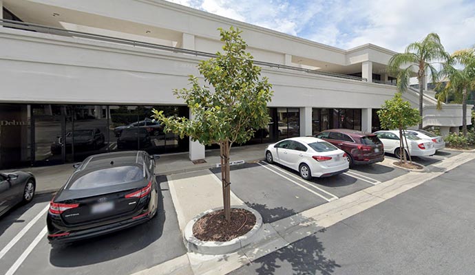 Several cars parked in front of office