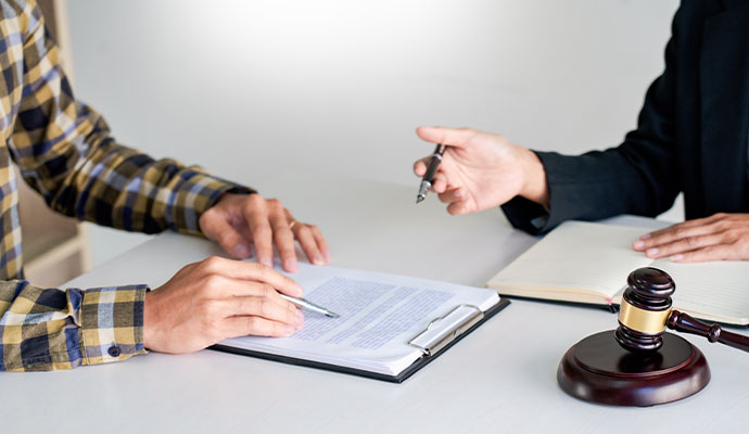 A legal professional and a client reviewing documents together