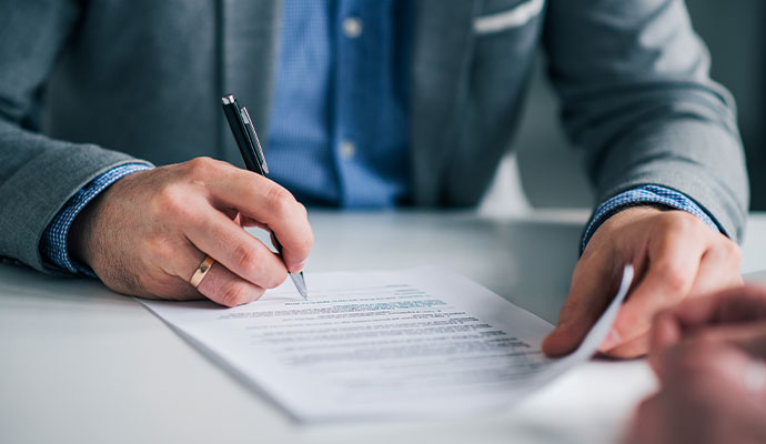 A professional signing a legal document